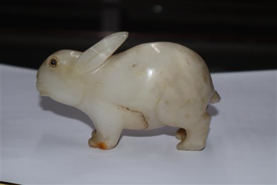 A 19th century Chinese white jade figure of a rabbit, glass inset eyes